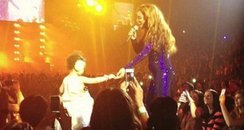 Beyonce with a todler on stage