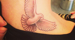 Rita Ora shows off her new bird tattoo