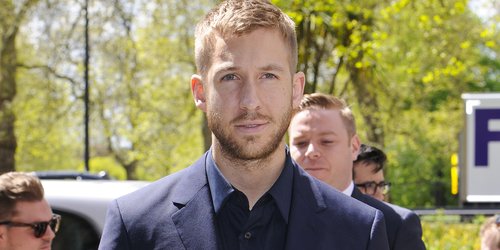 Calvin Harris at the Ivor Novello Awards wearing a suit