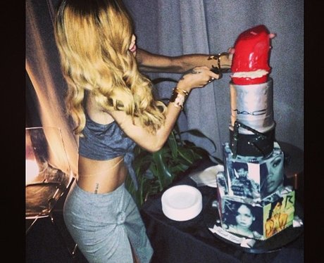Rihanna cutting a cake on her world tour