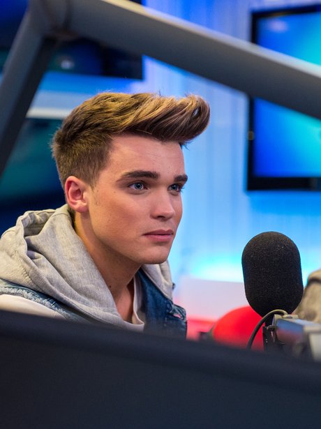 Union J's Josh speaks into the microphone in the Capital studio