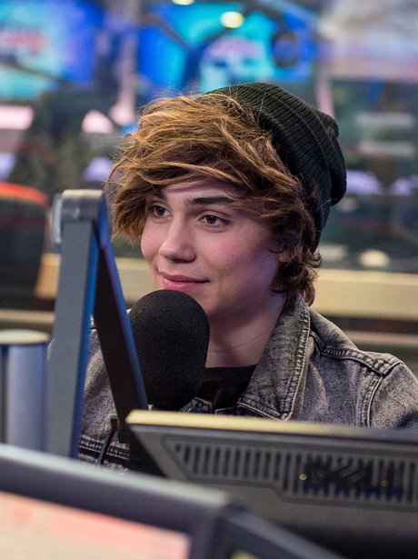 George speaking into a mircrophone