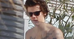 Harry Styles shows off his tattoos on holiday