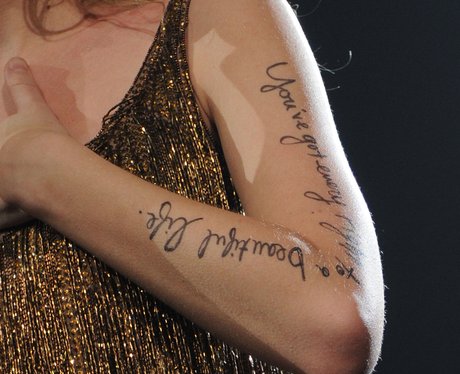 Taylor swift has Selan's lyrics on her arm