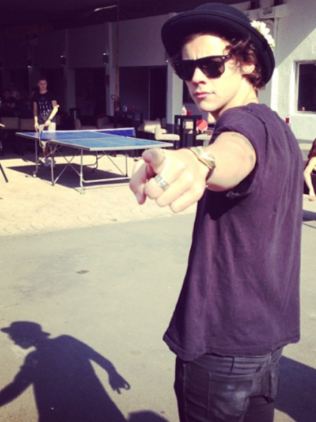 Harry Styles holding a guitar case in Miami