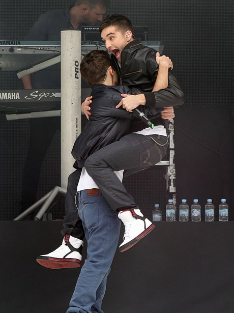 Tom Parker embraces Nathan Sykes during their performance