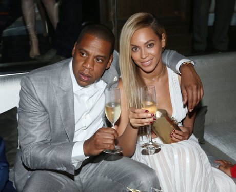 Beyonce and Jay-Z holding champagne glasses