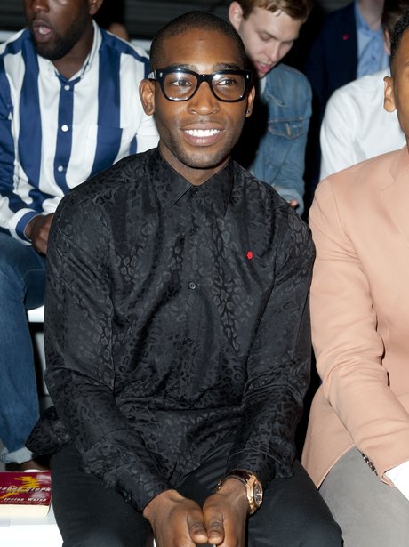 Tinie Tempah wearing black shirt on front row at Katie Eary