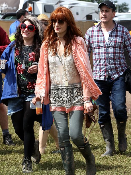 Florence Welch carrying a drink at Glastonbury