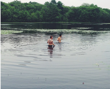 One Direction swimming in a lake