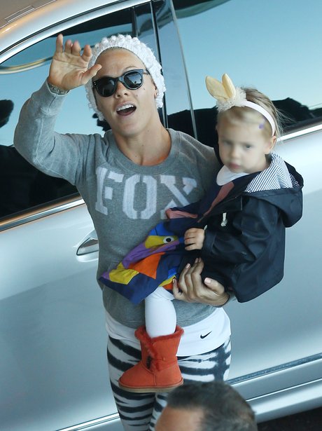 Pink carries her daughter Willow