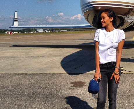 Rihanna poses outside of her private jet
