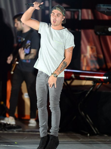 Max George performing on stage