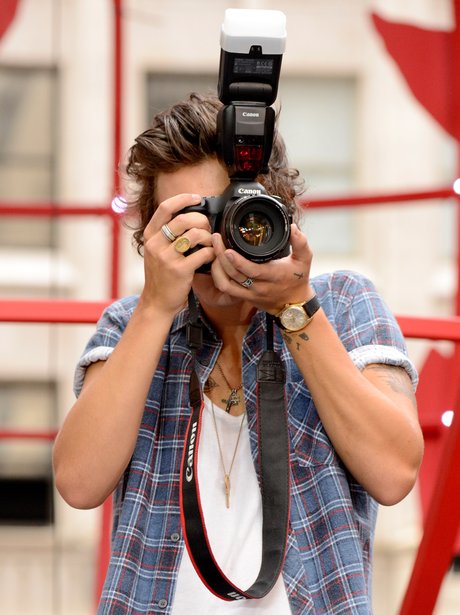 Harry Styles taking a picture