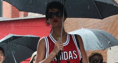 Rihanna using an umbrealla in the rain