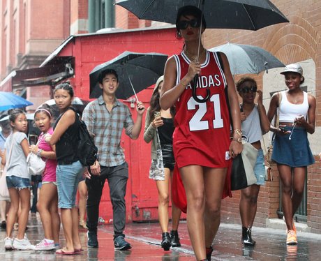 Rihanna using an umbrealla in the rain