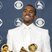 Image 1: Kanye West holding Grammy Awards