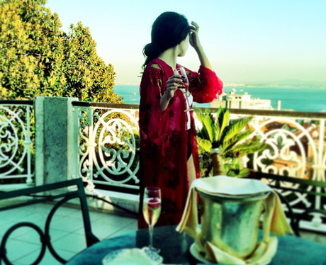 Selena Gomez surveys her balcony in Lisbon in Portugal