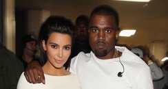Kim Kardashian and Kanye West dressed in white