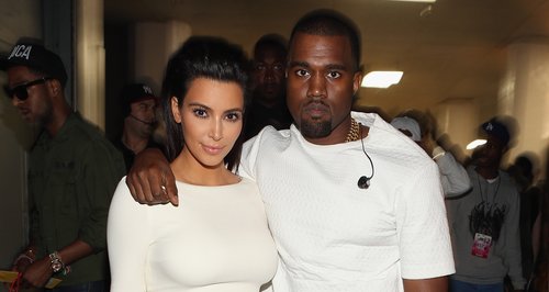 Kim Kardashian and Kanye West dressed in white