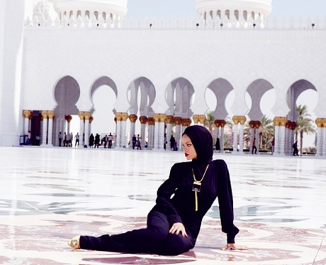 Rihanna poses outside a mosque