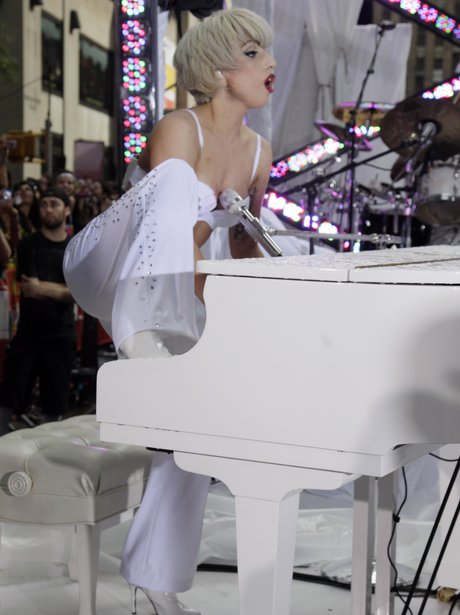 Lady Gaga playing the piano in concert