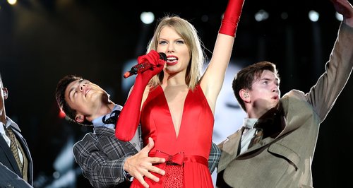 Taylor Swift on stage in a red dress