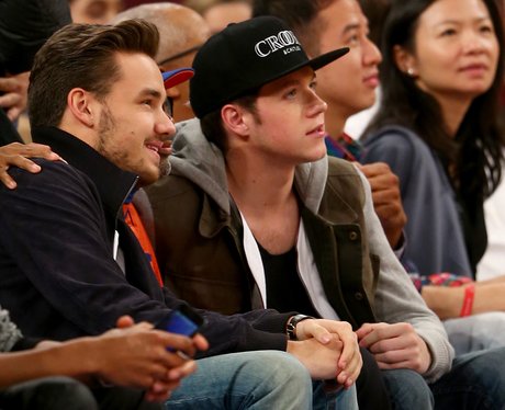 Liam Payne and Niall Horan wtch the basketball