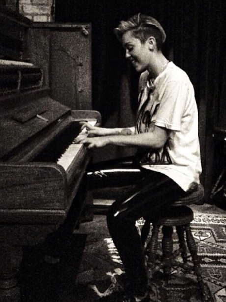 Miley Cyrus playing the piano