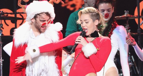Miley Cyrus on stage with santa