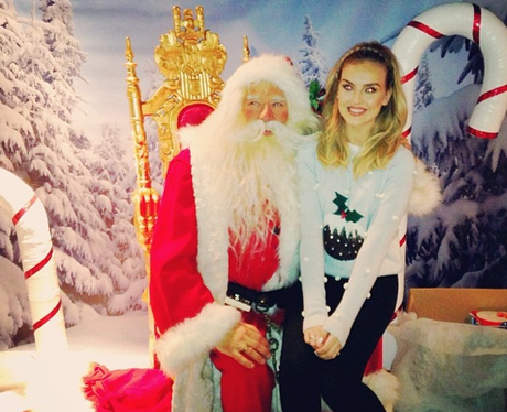 Perrie Edwards sits on Santa's knee