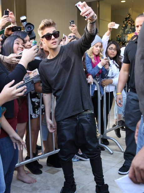 Justin Bieber takes a picture with fans