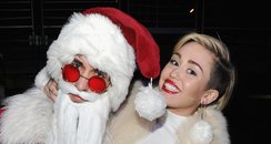 Miley Cyrus poses with Santa