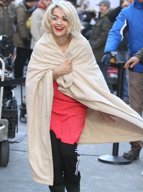 Rita Ora plays on a DKNY photo shoot in New York.