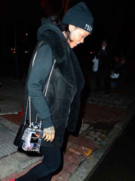 Rihanna carrying her chanel perfume bottle purse