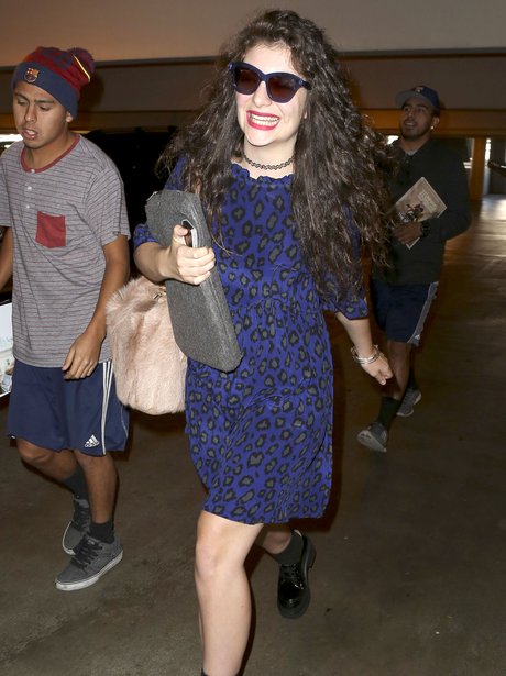 Lorde smiling at the airport