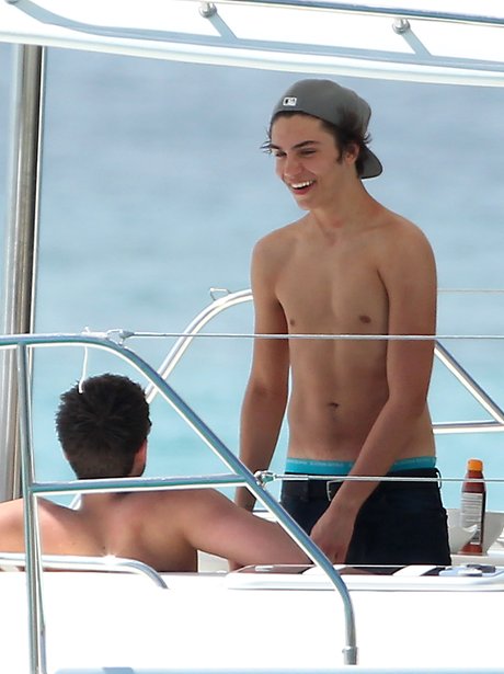 George Shelley topless on a boat in Barbados