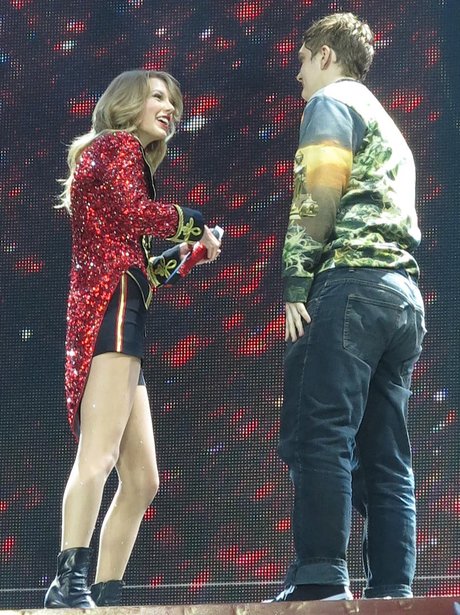 A fan joins Taylor Swift on stage