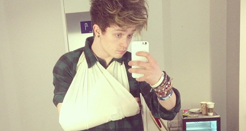 Conor from The Vamps with a sling