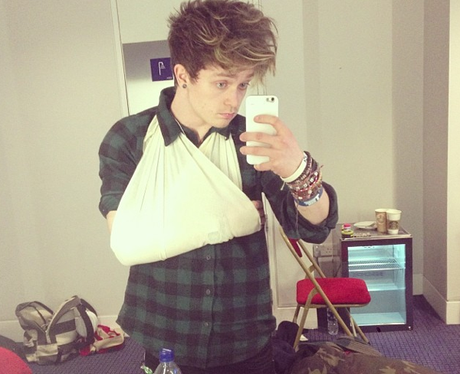 Conor from The Vamps with a sling