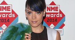 Lily Allen in an orange and black dress