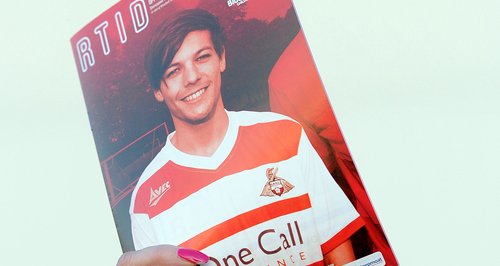 Louis Tomlinson on the cover of a matchday program