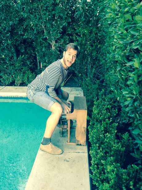 olly murs with miniature piano by the pool