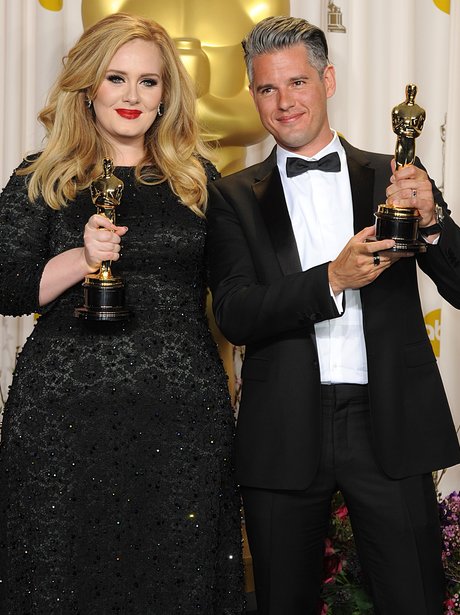 Adele and Paul Epworth hold up their awards