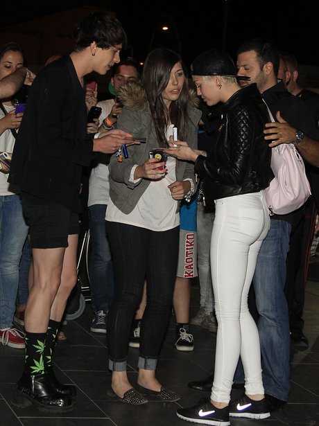Miley Cyrus greeting fans at the airport