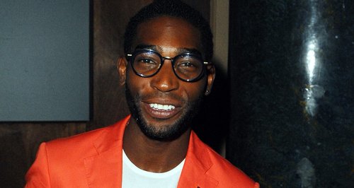 Tinie Tempah wearing a orange suit 