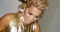 Rita Ora wearing a gold outfit