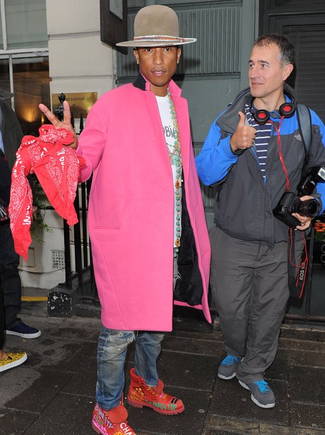 Pharell wearing a pink coat