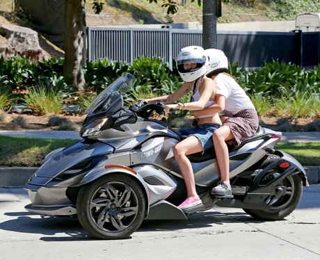 Miley Cyrus and Noah riding a motorbike