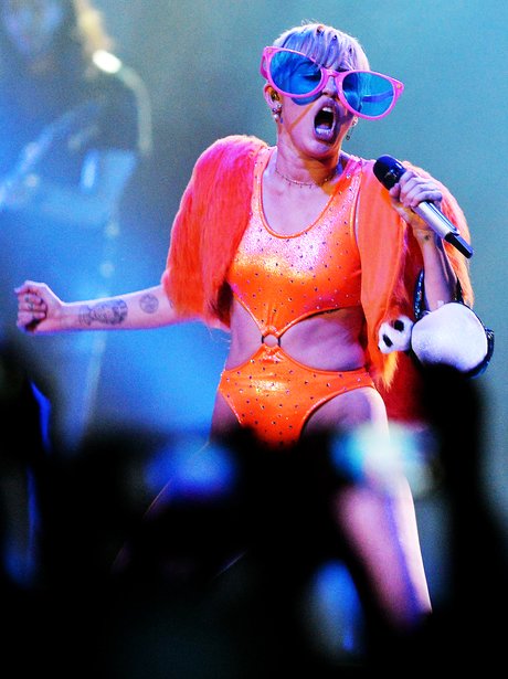 Miley Cyrus wearing glasses on stage